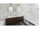 Modern bathroom featuring double sinks, marble countertops, and a tiled shower with gold fixtures at 5163 W Dolphin St, North Charleston, SC 29405
