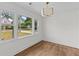 Bright bedroom featuring hardwood floors, white walls, and large windows at 5163 W Dolphin St, North Charleston, SC 29405