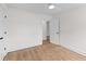 Bright bedroom featuring hardwood floors, white walls, and an open doorway at 5163 W Dolphin St, North Charleston, SC 29405