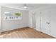 Light-filled bedroom with hardwood floors, white walls, ceiling fan, and a bathroom doorway at 5163 W Dolphin St, North Charleston, SC 29405
