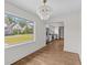 Inviting dining area with hardwood floors, large window, and stylish chandelier at 5163 W Dolphin St, North Charleston, SC 29405
