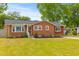 Charming brick home with a well-manicured lawn and landscaping at 5163 W Dolphin St, North Charleston, SC 29405