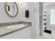 Bathroom featuring a round mirror, towel bar, and vanity with countertop sink and storage below at 521 Pelzer Dr, Mount Pleasant, SC 29464
