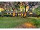 Well-maintained brick home with large trees, lush lawn and a well-lit walkway to the front door at 521 Pelzer Dr, Mount Pleasant, SC 29464
