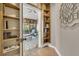 Hallway featuring built-in bookcases looking into a sunroom at 521 Pelzer Dr, Mount Pleasant, SC 29464