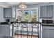 This kitchen has a bar with seating, gray cabinets, and stainless steel appliances at 521 Pelzer Dr, Mount Pleasant, SC 29464