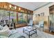 The sunroom is well-lit with wood walls and beautiful outdoor views at 521 Pelzer Dr, Mount Pleasant, SC 29464