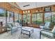 Beautiful sunroom with wood paneling, comfortable seating, and plenty of natural light at 521 Pelzer Dr, Mount Pleasant, SC 29464