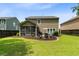 Well-maintained backyard with a screened-in porch, inviting seating area, and lush green lawn at 5451 Kings River Dr, North Charleston, SC 29420
