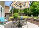 Backyard patio featuring an umbrella-covered table, comfortable chairs, and a well-manicured lawn at 5451 Kings River Dr, North Charleston, SC 29420
