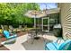 Charming backyard patio with colorful umbrella, seating, and a screened porch perfect for entertaining at 5451 Kings River Dr, North Charleston, SC 29420