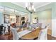 Open-concept dining room with a hardwood floor, overhead lighting, and open to another sitting area at 5451 Kings River Dr, North Charleston, SC 29420