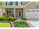 Inviting front entrance with a well-maintained lawn, manicured shrubs, and a charming porch with cozy seating at 5451 Kings River Dr, North Charleston, SC 29420