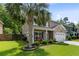 Charming two-story home with lush landscaping, a welcoming front porch, and a spacious front lawn at 5451 Kings River Dr, North Charleston, SC 29420