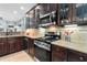 The kitchen has dark wood cabinetry, stainless steel appliances, and granite countertops at 5451 Kings River Dr, North Charleston, SC 29420