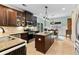 Kitchen with an island, stainless steel appliances, and dark wood cabinetry. A dining area is adjacent at 5451 Kings River Dr, North Charleston, SC 29420