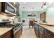 Modern kitchen featuring stainless steel appliances, gas range, granite counters, and an adjacent dining area at 5451 Kings River Dr, North Charleston, SC 29420