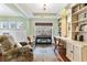 Sitting area with a piano, built-ins, hardwood flooring, wainscoting, and three large windows at 5451 Kings River Dr, North Charleston, SC 29420