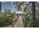 Scenic view from a wooden boardwalk leading to a marsh overlooking the tranquil waters at 5451 Kings River Dr, North Charleston, SC 29420