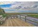 Scenic view from a wood deck overlooking a tranquil marsh landscape with blue skies and puffy clouds at 5451 Kings River Dr, North Charleston, SC 29420
