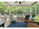 Cozy screened porch with comfortable seating, perfect for relaxing and enjoying the beautiful backyard view at 5451 Kings River Dr, North Charleston, SC 29420
