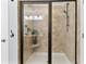 Tiled shower with glass enclosure, bench seat, and shower head at 5451 Kings River Dr, North Charleston, SC 29420
