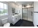 Elegant bathroom featuring a double vanity, illuminated mirrors, and a modern glass-enclosed shower at 5841 Kirkwood Ave, North Charleston, SC 29406