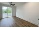 Bedroom with wood floors, ceiling fan, and sliding glass doors to a balcony at 5841 Kirkwood Ave, North Charleston, SC 29406