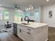 Contemporary kitchen island with stainless steel dishwasher and black water faucet at 5841 Kirkwood Ave, North Charleston, SC 29406