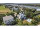 Stunning aerial view of the house with a private pool nestled amidst lush greenery and waterfront community at 6 Intracoastal Ct, Isle of Palms, SC 29451
