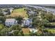 Aerial view of home with a pool, greenery, and neighborhood golf course in background at 6 Intracoastal Ct, Isle of Palms, SC 29451