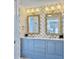 Elegant bathroom with a double vanity, ornate mirrors, stylish lighting and floral wallpaper at 6 Intracoastal Ct, Isle of Palms, SC 29451