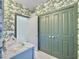 Well-appointed bathroom featuring double doors, stylish sink, and marble countertops at 6 Intracoastal Ct, Isle of Palms, SC 29451