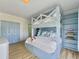 Charming bedroom with blue bunk bed, playful wallpaper, and built in shelving at 6 Intracoastal Ct, Isle of Palms, SC 29451