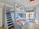 Cozy bedroom featuring a unique bunk bed, patterned wallpaper, and a sunlit window at 6 Intracoastal Ct, Isle of Palms, SC 29451