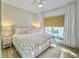 Serene bedroom featuring a plush bed, patterned wall, and natural light from the window at 6 Intracoastal Ct, Isle of Palms, SC 29451