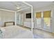 Bright bedroom featuring a four-poster bed, ceiling fan, and access to a private balcony at 6 Intracoastal Ct, Isle of Palms, SC 29451