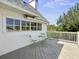 Outdoor deck with gray floorboards, white railings, seating and treetop views at 6 Intracoastal Ct, Isle of Palms, SC 29451