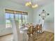 Inviting dining room with stylish light fixture and multiple windows for plenty of natural light at 6 Intracoastal Ct, Isle of Palms, SC 29451