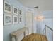 Upstairs hallway with beautiful artwork, light blue walls, and decorative wall sconce at 6 Intracoastal Ct, Isle of Palms, SC 29451
