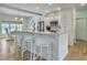 Beautiful kitchen with white cabinets, an island with seating, and stainless steel appliances at 6 Intracoastal Ct, Isle of Palms, SC 29451