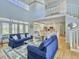 Spacious living room boasts high ceilings, hardwood floors, and access to an open-concept kitchen at 6 Intracoastal Ct, Isle of Palms, SC 29451