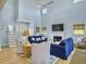Relaxing living area featuring a cozy fireplace, hardwood floors, and an abundance of natural light at 6 Intracoastal Ct, Isle of Palms, SC 29451