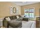 Comfortable living room with large sectional sofa, natural light, and view of golf course at 6 Intracoastal Ct, Isle of Palms, SC 29451