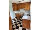 Classic kitchen featuring ample cabinetry, white countertops, and a checkered floor, ready for your personal touch at 609 Coral St, Mount Pleasant, SC 29464