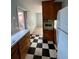 Functional kitchen space with wood cabinets and a black-and-white checkered floor, ready for customization at 609 Coral St, Mount Pleasant, SC 29464
