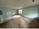 Bright and airy living room with large windows and neutral walls, providing a versatile space for relaxation and entertainment at 609 Coral St, Mount Pleasant, SC 29464