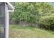 Backyard view featuring a large grassy area and a wooded fence line at 6260 Brandt St # 4-D, North Charleston, SC 29406