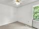 Bedroom with white walls, ceiling fan, and a window offering natural light at 6260 Brandt St # 4-D, North Charleston, SC 29406