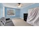 Bedroom featuring blue walls, neutral carpet, window, and ceiling fan at 6260 Brandt St # 4-D, North Charleston, SC 29406